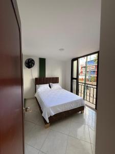 Postel nebo postele na pokoji v ubytování Hotel Alojamientos Villavicencio