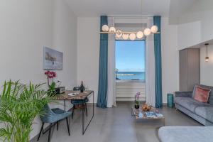 a living room with a couch and a table at Alta Marea Apulia sea view in Bari