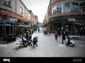 a group of people walking down a city street at Lake District Fully Furnished Home in Mossbay