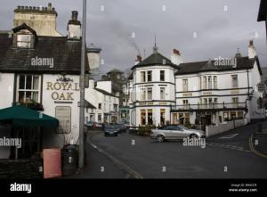 a city street with buildings and a car on the road at Lake District Fully Furnished Home in Mossbay