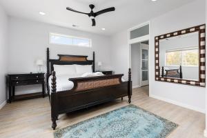 a bedroom with a bed and a mirror at Slabtown Penthouse - Modern Condo - Private Rooftop Deck 