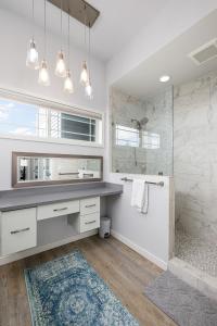a bathroom with a large sink and a shower at Slabtown Penthouse - Modern Condo - Private Rooftop Deck  +32 photos