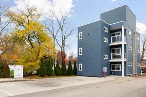 a blue building on a street with trees at Slabtown Penthouse - Modern Condo - Private Rooftop Deck 