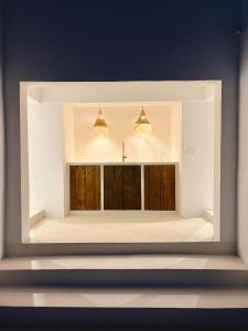 a mirror in a room with wooden doors at Casa Mimo Altea in Altea