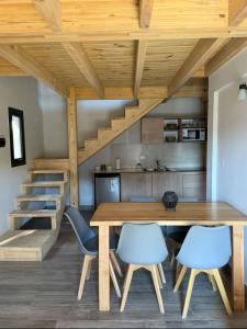 a kitchen and dining room with a wooden table and chairs at NB Mountain aparts El Chalten in El Chalten