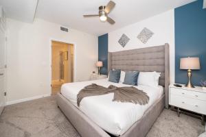 ein Schlafzimmer mit einem großen Bett und blauen Wänden in der Unterkunft 3120-206DR STOREY LAKE, CONDO 2/2 GARDEN VIEW in Kissimmee + 23 Fotos