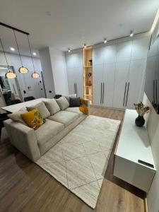 a living room with a couch and a table at Danubia-residence in Komárno