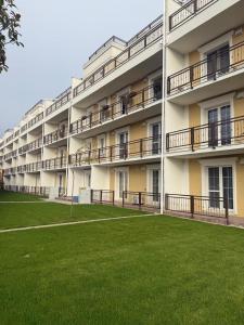 an apartment building with a lawn in front of it at Danubia-residence in Komárno