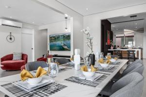 a dining room with a long table with chairs at Casa Placita Hotel in San Juan