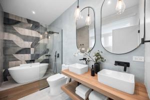 a bathroom with two sinks and a mirror at Casa Placita Hotel in San Juan +25 photos