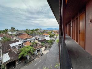 an apartment balcony with a view of a city at Balvanta Coliving in Kerobokan