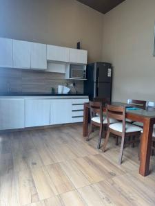 a kitchen with a table and chairs and a refrigerator at Mar Adentro Casa 13 in Santa Cruz de la Sierra