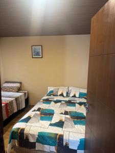 a bedroom with a bed with a quilt on it at Mar Adentro Casa 13 in Santa Cruz de la Sierra