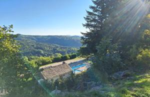 an aerial view of a house with a swimming pool at Auberge & Camping Sabatoux in Montusclat