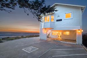 a house on the beach at sunset at Black Sands Inn in Whitethorn