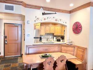 une cuisine avec une table en bois et une horloge au mur dans l'établissement Stylish 2B2B Zermatt Villa Near Park City & Deer Valley Ski Resorts - 6668, à Mound City