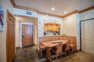 a kitchen with a wooden table in a room at Alpine-Style Zermatt King Villa with Full Kitchen Near Park City & Deer Valley Ski Resorts - 2068 in Mound City +9 photos