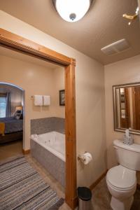 a bathroom with a toilet and a bath tub at Alpine-Style Zermatt King Villa with Full Kitchen Near Park City & Deer Valley Ski Resorts - 2068 in Mound City