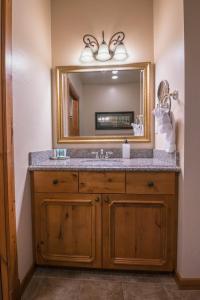 a bathroom with a sink and a mirror at Alpine-Style Zermatt King Villa with Full Kitchen Near Park City & Deer Valley Ski Resorts - 2068 in Mound City