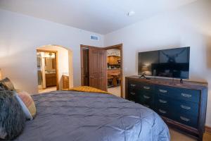 a bedroom with a bed and a flat screen tv at Alpine-Style Zermatt King Villa with Full Kitchen Near Park City & Deer Valley Ski Resorts - 2068 in Mound City