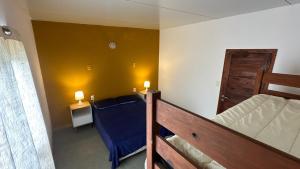 a small room with a bed and a bedroom with two lamps at Balconada Rooms in La Paloma