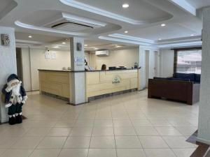 Ein Krankenzimmer, in dessen Lobby ein Weihnachtsmann steht. in der Unterkunft Bombinhas Blue Suítes in Bombinhas + 55 Fotos