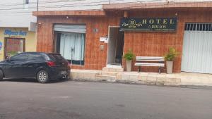 a black car parked in front of a hotel at Hotel 5 irmãos in Araripina