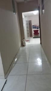 a hallway with a tile floor and a door at Hotel 5 irmãos in Araripina