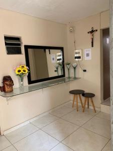 a room with two tables and a mirror on the wall at Hotel 5 irmãos in Araripina