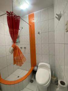 a small bathroom with a toilet and a shower at La casa de Betty in Huancayo