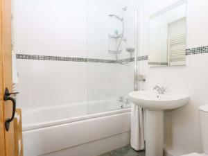 a bathroom with a tub and a sink and a shower at Curragho in Trearddur +32 photos