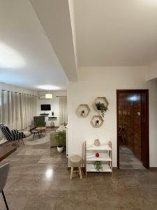 a living room with white walls and a table and chairs at sea view in Stilís