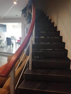 a staircase in a house with a red rail at La casa de Betty in Huancayo