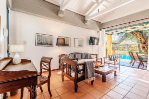 a living room with a piano and a table at Barbati Beach - Villa Ithika in Barbati +16 photos
