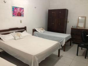 Ένα ή περισσότερα κρεβάτια σε δωμάτιο στο Recanto do Cajueiro - Luís Correia - Piauí