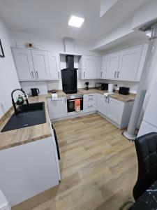 a kitchen with white cabinets and a sink at Union House in Stratford-upon-Avon