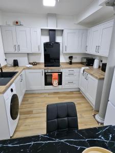 a kitchen with white cabinets and a stove top oven at Union House in Stratford-upon-Avon +18 photos