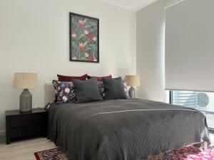 una camera da letto con un letto e un quadro sul muro di Stylish CBD Retreat with 3BR,3BA,Balcony,2 Parking a Adelaide