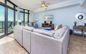 a living room with a couch and a ceiling fan at The Oasis 405 formerly Phoenix West II 405 condo in Romar Beach