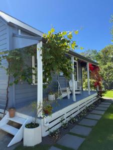a house with a tree on the front porch at Clive Cottage in Clive