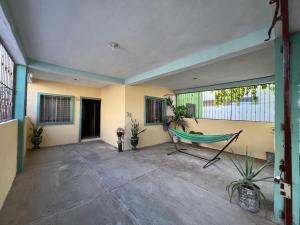 a room with a hammock and plants in it at Casa en Manzanillo in Manzanillo