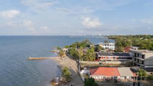an island in the water with houses and trees at Casa Claro del Mar in Coveñas