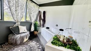 a bathroom with a tub and a toilet and a sink at Couple's Spa Retreat Resort Villa with complimentary champagne upon arrival in Cowes