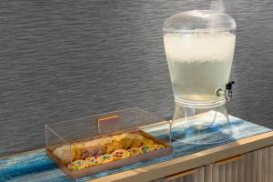 a glass of milk next to a box of candy at Solita Soho Hotel in New York