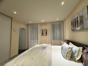 Schlafzimmer mit einem großen weißen Bett in der Unterkunft Border Bliss - Private Room with Bathroom in a Cozy Home in Kerkrade