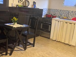 a kitchen with a table and a stove at La morada del Norte in Roque Sáenz Peña