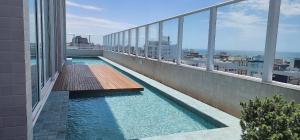 a balcony with a swimming pool on a building at Dream Apartment-Rooftop, Pool, Mountain & Sea View in Capão da Canoa