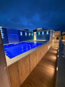 a swimming pool on the roof of a building at night at Hotel Sheik Business in Rio de Janeiro