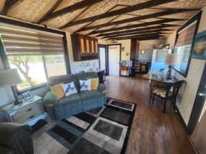 a living room with a couch and a table at Quail Covey Cottage in Hereford Airport