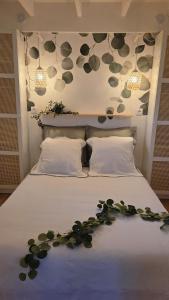 a bedroom with a bed with a flower arrangement on it at Cottage Atypique in Saint-Laurent-de-la-Prée